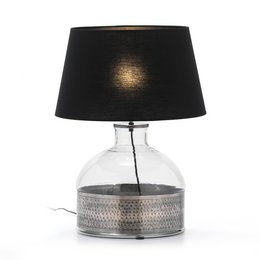 A clear glass table lamp with a silver-colored base and a black fabric shade. The base has a textured, hammered pattern.