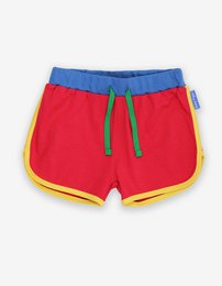 Red, blue, and yellow kids' jogging shorts made from organic cotton. Available in sizes 6-12 months to 5-6 years.