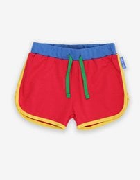 Red, blue, and yellow kids' jogging shorts made from organic cotton. Available in sizes 6-12 months to 5-6 years.