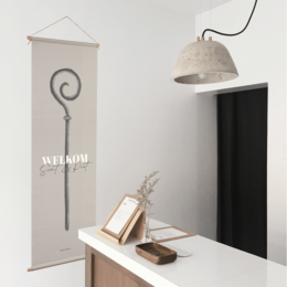 Textile poster with "Welcome Sint & Piet" text, featuring a decorative spiral design, available in 40x120 cm size.