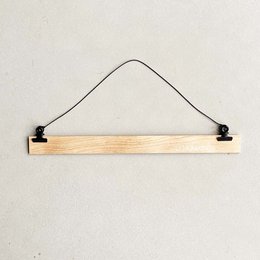 Wooden hanging system for A3 size posters, with black metal hooks for easy installation.