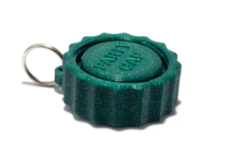 A green, round festival cap with a textured surface and a metal ring for attachment.