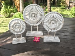 Decorative stone statues with intricate floral designs, suitable for indoor or outdoor display in a garden or home setting.