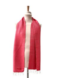 A warm, coral-orange scarf with a textured, woven pattern. Made of high-quality materials for a luxurious feel.