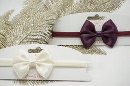 Nylon hairband with satin bow in a variety of colors including white, pink, blue, and black. Suitable for kids' hair accessories.