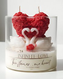 "Two heart-shaped red scented candles with a white base and the text 'Infinite Love' on the product."
