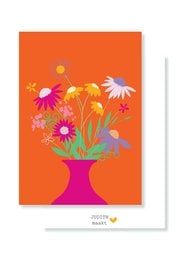 Vibrant bouquet of colorful flowers in a vase against an orange background.