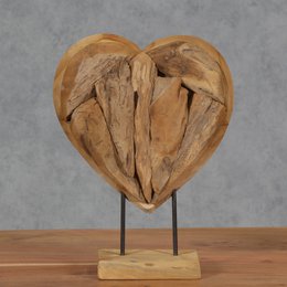 A wooden heart-shaped sculpture with a rustic, natural appearance. The sculpture is made of carved wood pieces arranged in a heart shape and mounted on a wooden base.