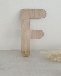  Wooden wall decor with the text "Let's play" in a circular frame, featuring wooden balloon shapes in various sizes.
