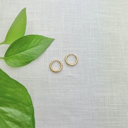 Gold hoop earrings in 15mm, 20mm, and 11mm sizes. Minimalist and versatile hoops that can be worn for any occasion.