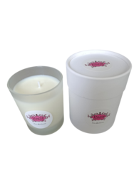 A tall, round white candle with a pink floral label, featuring the scent of orange blossom.