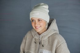 Cozy beige knit beanie with a folded brim, perfect for keeping warm in cold weather.