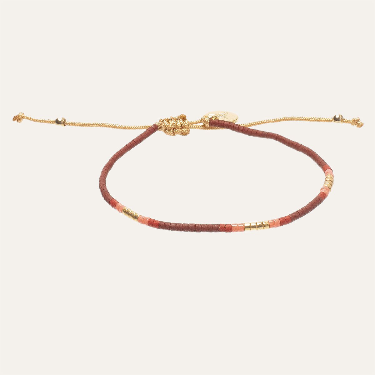 gold bracelet with red