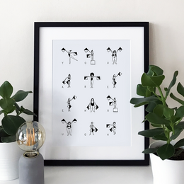 "Wall art featuring abstract human figures in various poses. The artwork has a minimalist, black and white style."