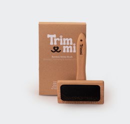 Bamboo pet brush with soft bristles for grooming and removing pet hair.