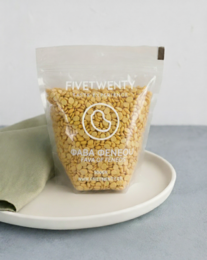 Organic Fava beans, 500g. Dried, whole fava beans in a clear plastic bag with a label.