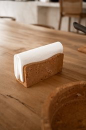 "Cork napkin holder, natural wood texture, rectangular shape, modern minimalist design, earth tones"