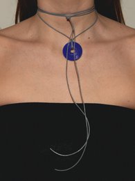 A round, blue pendant necklace with a leather cord. The necklace has a simple, minimalist design and is available in a variety of colors including beige, black, grey, pink, purple, chocolate, ocean green, white, khaki, and mint.
