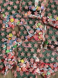 Colorful DIY bracelet making kit for kids, includes assorted beads and charms in star shapes.