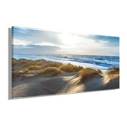 A large, rectangular canvas wall art depicting a scenic coastal landscape with sand dunes, rolling waves, and a cloudy sky.