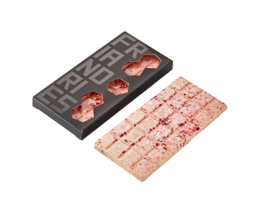 A rectangular chocolate bar with raspberry, yogurt, and cacao nibs. The chocolate bar is dark in color and has visible pieces of raspberry and cacao nibs embedded in it.
