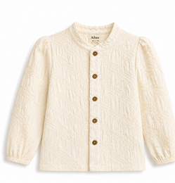 Cream textured cotton blouse with puffed sleeves and wooden button front closure.