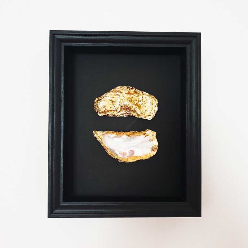Double golden oysters in black wooden frame