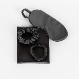 Charcoal gray sleep set with silk pillowcase, hair scrunchies, and eye mask for restful sleep.