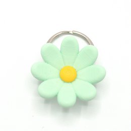 Mint green daisy flower keychain with yellow center, soft plush material, floral design accessory