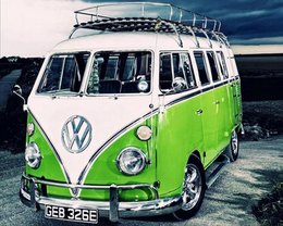 Vintage green and white Volkswagen bus with roof rack, classic retro camper van design.
