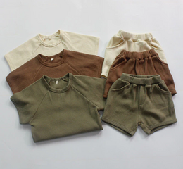Children's summer clothing set in beige, khaki, and brown colors. Includes tops and shorts in sizes 12-18M, 18-24M, 2-3Y, 3-4Y, 5-6Y, and 7-8Y.