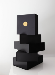 A modern, minimalist black box set with a gold accent, suitable for serving mocktails or cocktails.