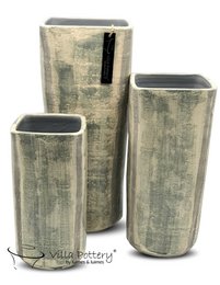 A set of three tall, cylindrical vases in a distressed, khaki-colored finish. The vases have a simple, minimalist design and appear to be made of a durable material, possibly ceramic or concrete. The varying sizes of the vases suggest they could be used together or separately to display flowers, plants, or other decorative items.