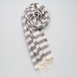 Soft, handwoven cotton scarf in grey and white striped pattern with fringed edges.