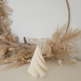Decorative pillar candle made from rapeseed wax with a swirl design, suitable for Christmas decor.