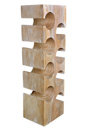 Wooden wine shelf with circular cutouts for storing wine bottles. Made of natural wood with a rustic, minimalist design.