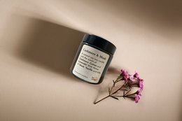 A round, tall white candle with a label that reads "Cashmere & Musk 100g". The candle is made of high-quality materials and has a soothing, luxurious scent.