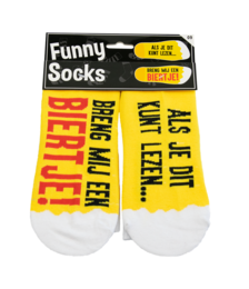 White socks with yellow polka dots and text "Bring me a beer" printed on them.