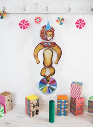 Colorful, whimsical nursery mobile with a circus-themed lion figure and spinning pinwheel shapes in vibrant hues.