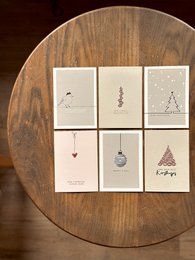 Colorful, stylized cards with pictures depicting a wine glass and a person's legs. The cards come in various sizes and colors including black, pink, and blue.