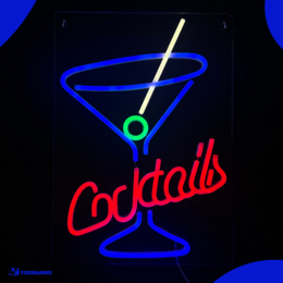 Neon cocktail sign with martini glass and text. Vibrant neon lighting in red and blue colors. Suitable for bar, lounge, or home decor.
