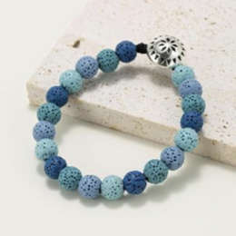 Round beaded bracelet made of natural lava stone in shades of blue.