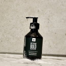 Nourishing bald head shampoo with no hair. Formulated for scalp care, this shampoo is designed for those with bald or thinning hair. The black bottle with a pump dispenser suggests a high-quality, professional-grade product.