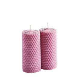Two tall, cylindrical beeswax candles in a light pink color with a honeycomb pattern texture.