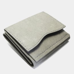 Minimal wallet made of paper in a neutral stone color. Compact and slim design with card slots and a cash compartment.