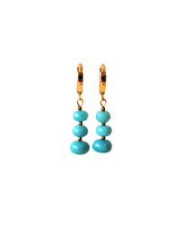 Turquoise blue beaded drop earrings with gold-tone hoop clasps, gemstone jewelry.