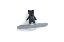 Black plastic figure on a gray snowboard.