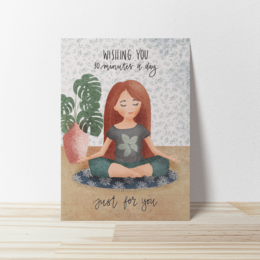  Greeting card with a woman sitting in a meditative pose, surrounded by plants. The text on the card says "Wishing you moments of joy".