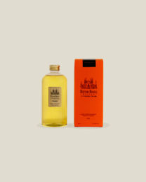  A glass reed diffuser bottle filled with a dark amber-colored liquid, likely the fragrance refill for the Porta Romana Dr. Angeli Milan reed diffuser.