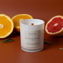 Tall, round white candle with a warm, citrus scent inspired by the flavors of France.